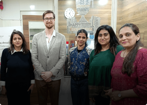 Group picture of students and counsellors posing happily at a pre-departure event at EduOptions’ Mumbai office.