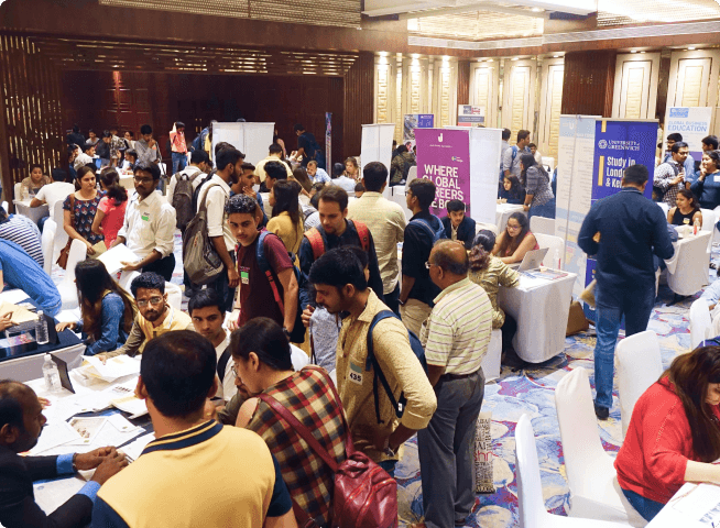 A student engrossed in reading a brochure at an exhibition.